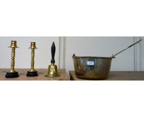 A brass jam pan together with brass ladle, a pair of brass candlesticks and a school bell (5)