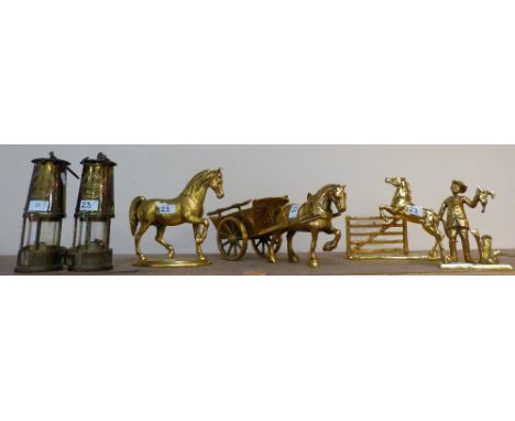 A pair of miner's lamps together with brass horse, brass horse and cart, brass horse rearing in a gate and brass huntsman