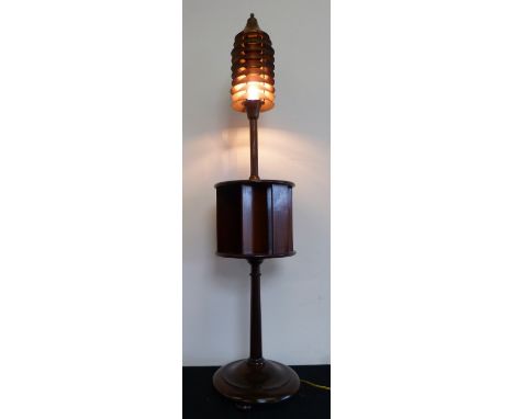 An unusual mahogany revolving bookcase and standard lamp, the lamp composed of ten louvred cone shaped panels, rewired, 140cm