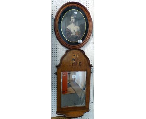 An oak framed bevel edged wall mirror, the frame featuring a cello player and bottom shelf, together with an oval portrait pr