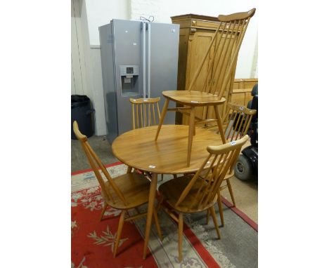 An Ercol blond elm oval dining table, 100cm long, together with a set of five Ercol stick back dining chairs with elm seats (