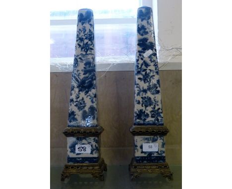 A pair of Chinese ceramic and gilt metal obelisks