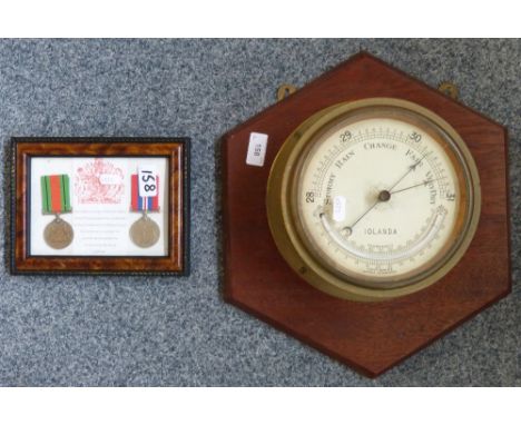 A Lennie Edinburgh ship's barometer inscribed "Iolanda" mounted on mahogany base together with two WWII medals in frame (2)