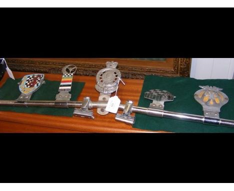 A series of car bonnet badges, sporting names such as British Automobile Racing Club and Royal Automobile Racing Club