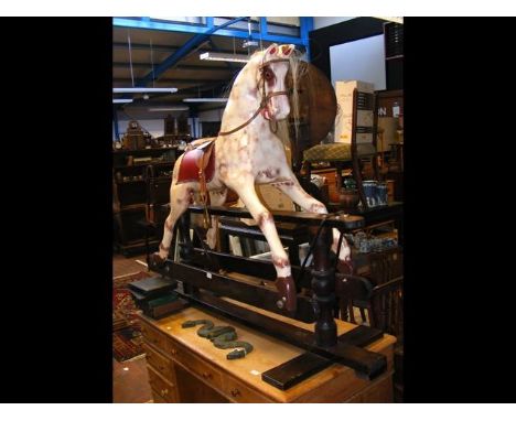 A vintage 4ft high painted rocking horse with leather saddle CONDITION REPORTworks fine and seems ok