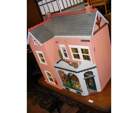 A model dolls house with shop front, complete with extensive furnishings - width 60cm