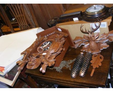 A reproduction cuckoo clock with cone weights together with an oak barometer