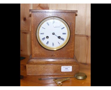 A Charles Frodsham oak cased mantel clock with two train movement and brass bob pendulum, back plate engraved C.F - height 23