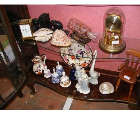A pair of elephant bookends, reproduction carriage clock, another clock, masons iron stone jug and plate, ceramic bells etc -