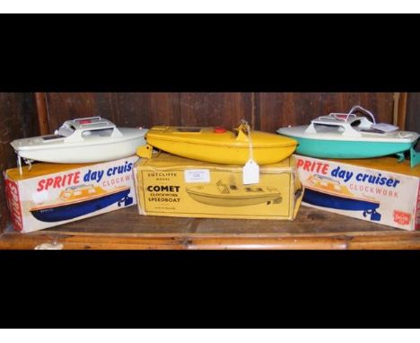 Two Sprite Clockwork Day Cruisers in boxes, together with a Sutcliffe model Comet Clockwork Speedboat in box 