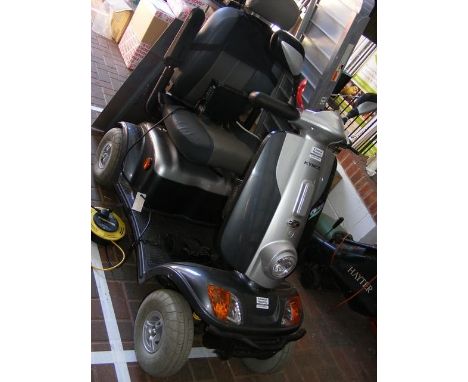 A Kymco For U four wheel mobility scooter in two-tone grey, with battery charger and loading ramps