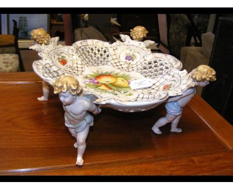 A continental ceramic fruit bowl with cherub supports 