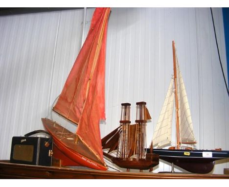 Three model sailing boats and a vintage Roberts Radio 