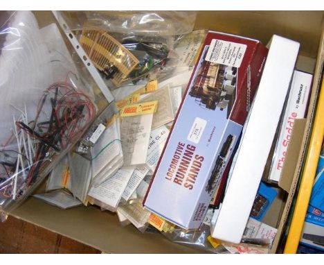 A plastic container with model railway kits, track, etc. 