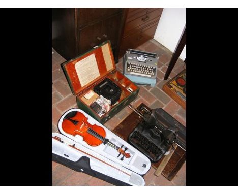 An old Oliver typewriter, together with a Brother, photographic equipment and violin 