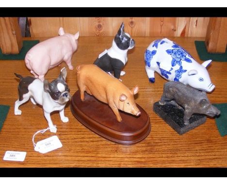 Two ceramic dogs together with four figures of pigs