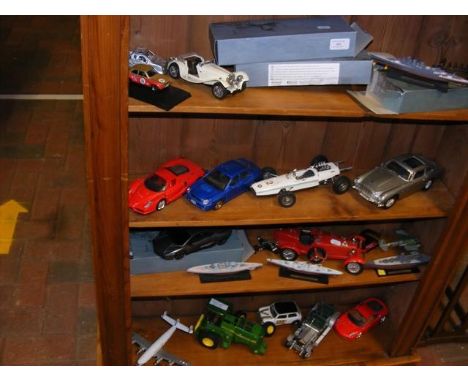 A Lockheed Constellation diecast aeroplane together with other model cars and naval vessels - on four shelves
