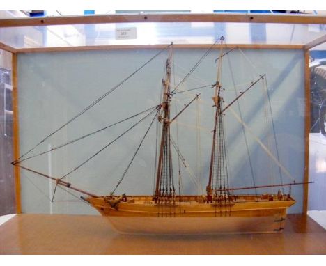 A wooden model two masted boat in glazed display case - 46cm x 76cm 