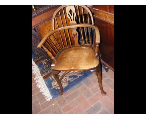An antique stick back armchair with crinoline stretcher  