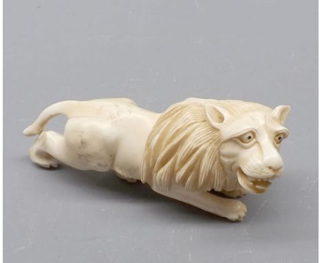 Oriental ivory carved model of a lion, 5" long 