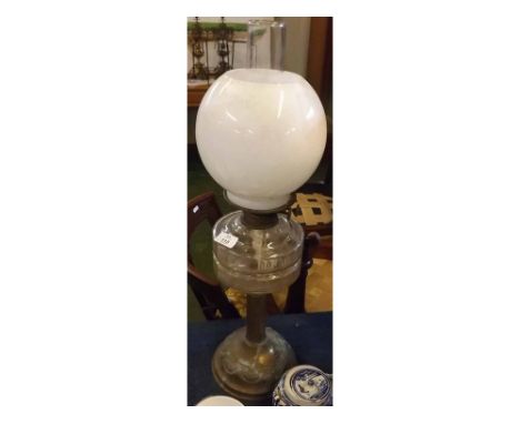 19th century oil lamp with clear glass chimney, opaque glass shade, clear glass font, raised on a brass base 
