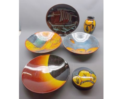 Mixed Lot: 20th century Poole Pottery wares to include four decorated circular dishes, covered circular box and a further vas