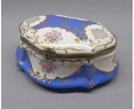 20th century Limoges dressing table trinket box, decorated with floral and gilt highlights, 8" long 