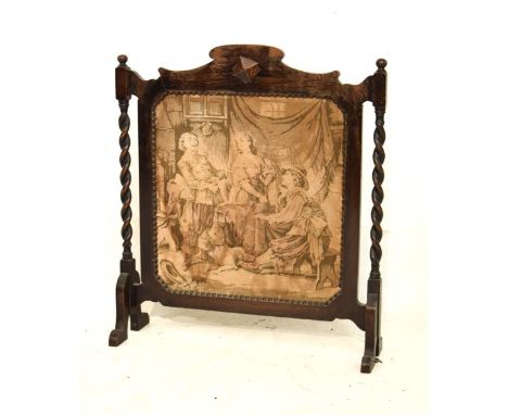 Early 20th Century oak framed firescreen having a machine made tapestry panel depicting figures in an interior, within beaded