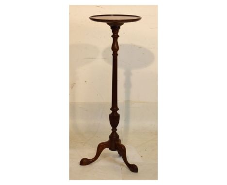 Old reproduction mahogany torchère or lamp stand in the Georgian taste, the circular top with moulded edge on fluted turned s