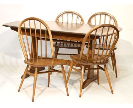 Ercol extending dining table, fitted one insertion with four hoop back elm seat dining chairs   Condition: 