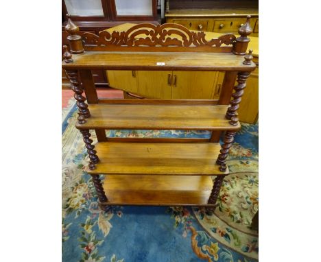 A VICTORIAN MAHOGANY FOUR SHELF WHATNOT with fretwork top rail, barley twist shelf dividers and finial caps, on turned bun fe