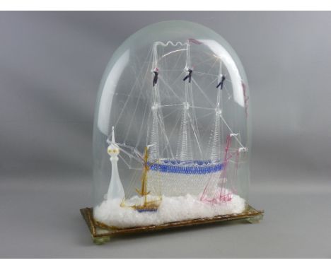A VICTORIAN NAILSEA GLASS FRIGGER, a three masted ship with crew to the rigging and anchor and chain, displayed with two smal