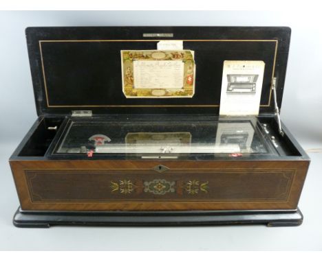 A GOOD SWISS CYLINDER MUSIC BOX playing twelve airs, the crossbanded rosewood case with boxwood stringing and multi-wood inla