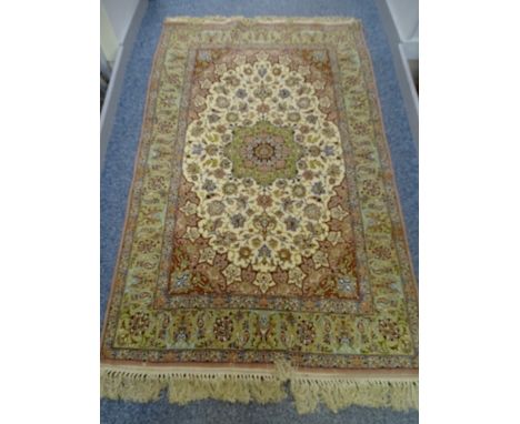AN ISAFAHAN WOOL RUG, three row floral panel with centre triple tiered panel of flowers in greens and delicate pinks on a faw
