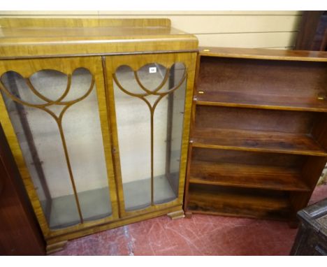 A VINTAGE WALNUT TWO DOOR CHINA DISPLAY CABINET and a mahogany open waterfall type bookcase, 121 x 86 cms and 111.5 x 78 cms 