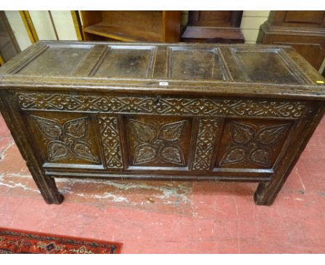 AN 18th CENTURY OAK DOWER CHEST, the four panel lift-up top with shaped moulding and rounded edging, opening to reveal an int