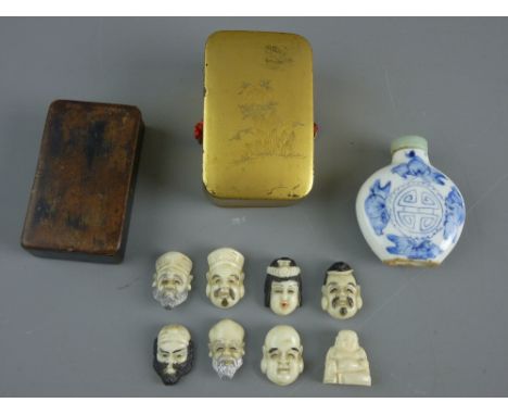 A JAPANESE GILT LACQUERED LIDDED BOX containing seven Ojime and a small figure of Budai, a snuff box and an opium bottle, the