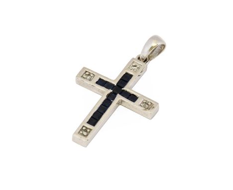 A 9 carat white gold sapphire and diamond cross pendant, a cross motif formed of calibré cut sapphires terminating to eight-c