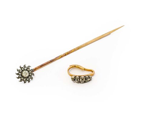 A diamond sunburst stick pin, the cluster formed of an old cut diamond to a radiating border of rose cut diamonds, in white m