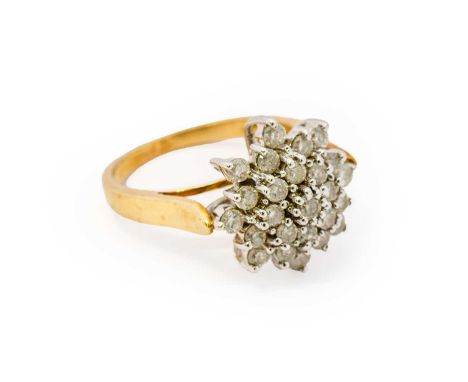 A 9 carat gold diamond cluster ring, the cluster formed of round brilliant cut diamonds in white claw settings, to a tapered 