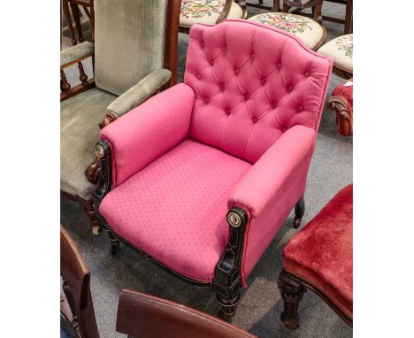 A Victorian parcel-gilt ebonised and pink upholstered button back chair, the arms inset with painted porcelain portrait round