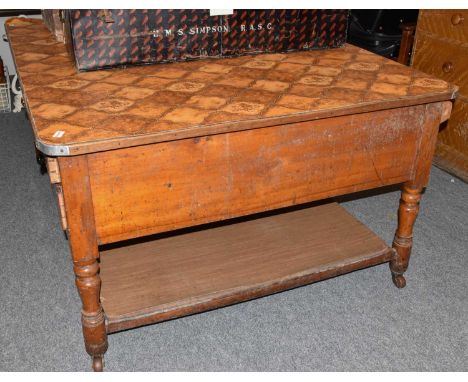 An imposing Victorian pine kitchen table, the later formica top above four frieze drawers, the opposing side for trays, raise