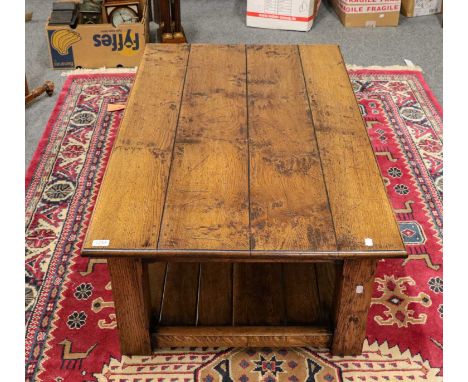 A 20th century Titchmarsh and Goodwin style oak coffee table with shelf stretcher 123cm by 75cm by 46cm