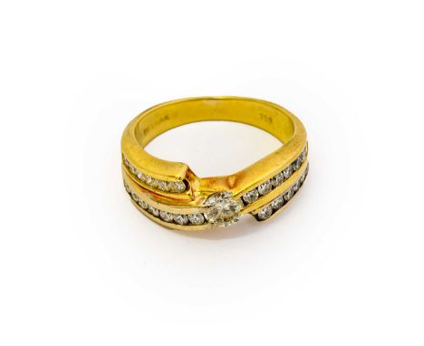 A diamond ring, the round brilliant cut diamond, in a yellow claw setting, flanked by a double row eight-cut diamond set twis