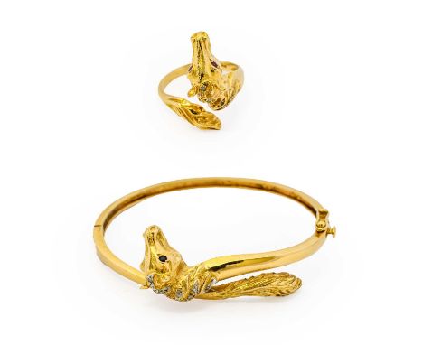 A diamond and sapphire horse hinged bangle, formed of a yellow textured horse head a tale motif, with round cut sapphire eyes