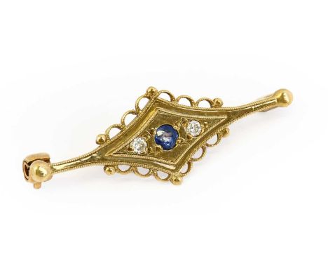 A 9 carat gold sapphire and diamond brooch, the round cut sapphire flanked by round brilliant cut diamonds, in a yellow trape