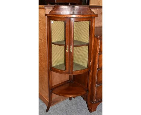 An Edwardian inlaid mahogany bow fronted and glazed corner display cabinet, 56cm by 40cm by 132cmCondition report: With a few