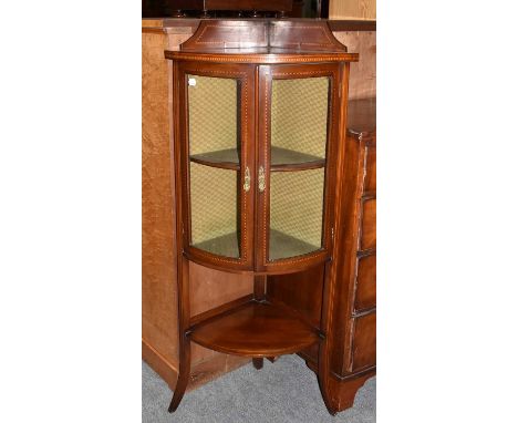 An Edwardian inlaid mahogany bow fronted and glazed corner display cabinet, 56cm by 40cm by 132cmCondition report: With a few