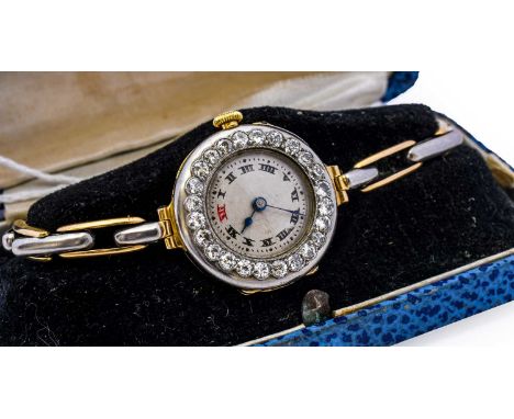 A lady's 18 carat gold diamond wristwatch, circa 1930, the circular dial with roman numerals with a red numeral at 12, within