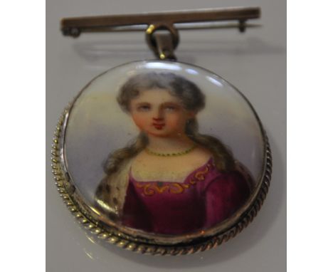 A porcelain portrait brooch of an aristocratic lady in oval white metal frame